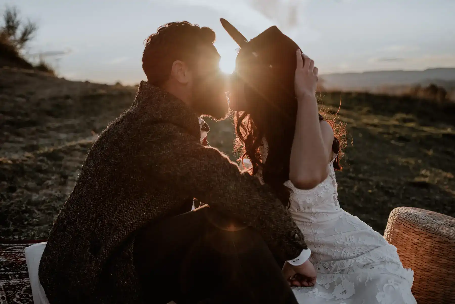 Couple kissing at sunset during elopement