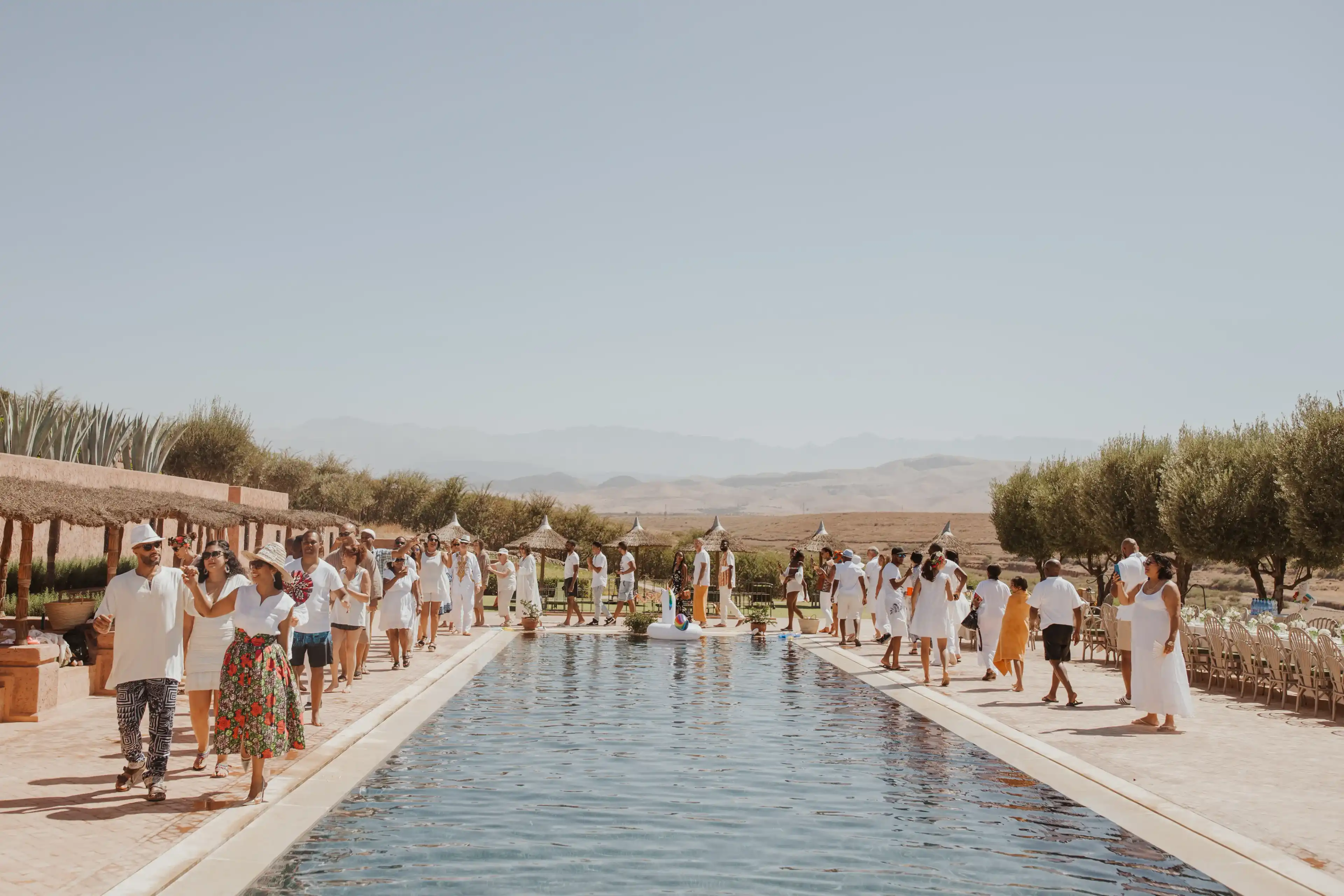 Couple and guests pool partying after wedding celebration in Marrakech